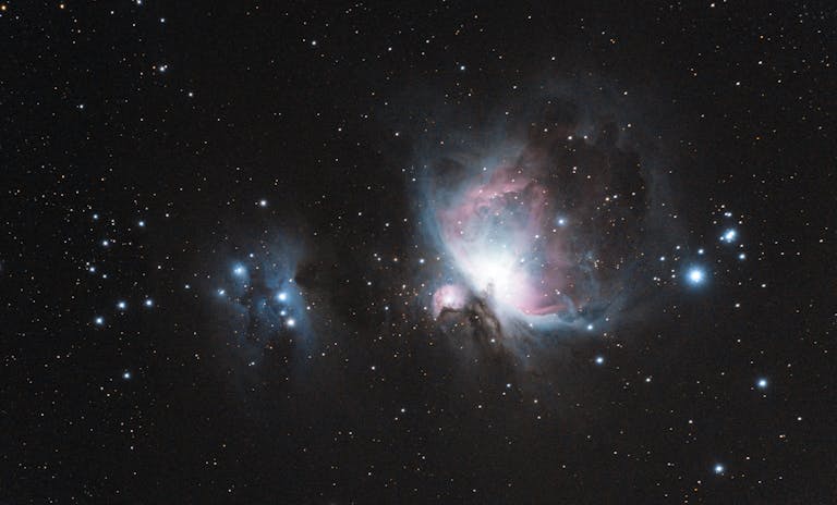 Capture of the Orion Nebula (M42) with stars and galaxies in a celestial scene.