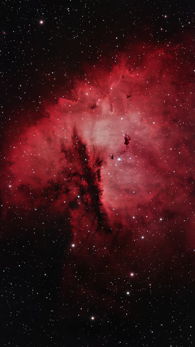 Vibrant red and dark hues of the North America Nebula, a stunning outer space capture.