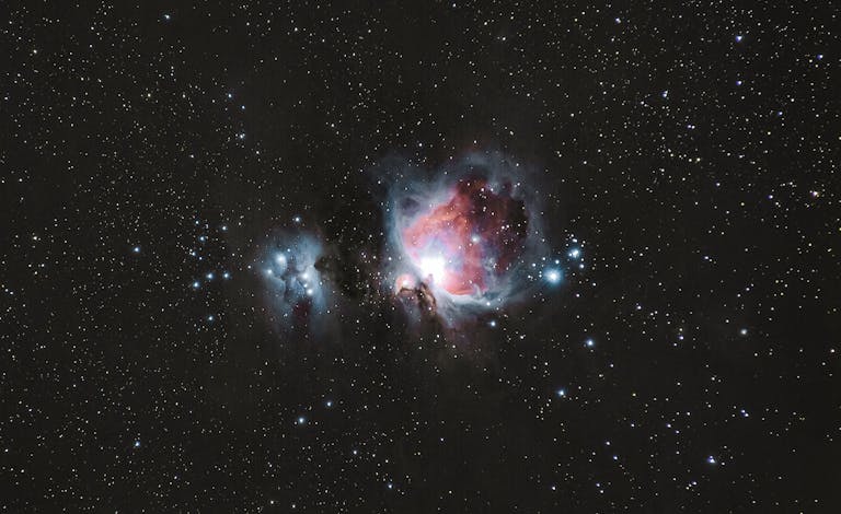 A breathtaking photograph of the Orion Nebula amidst a starry night sky, capturing celestial beauty.