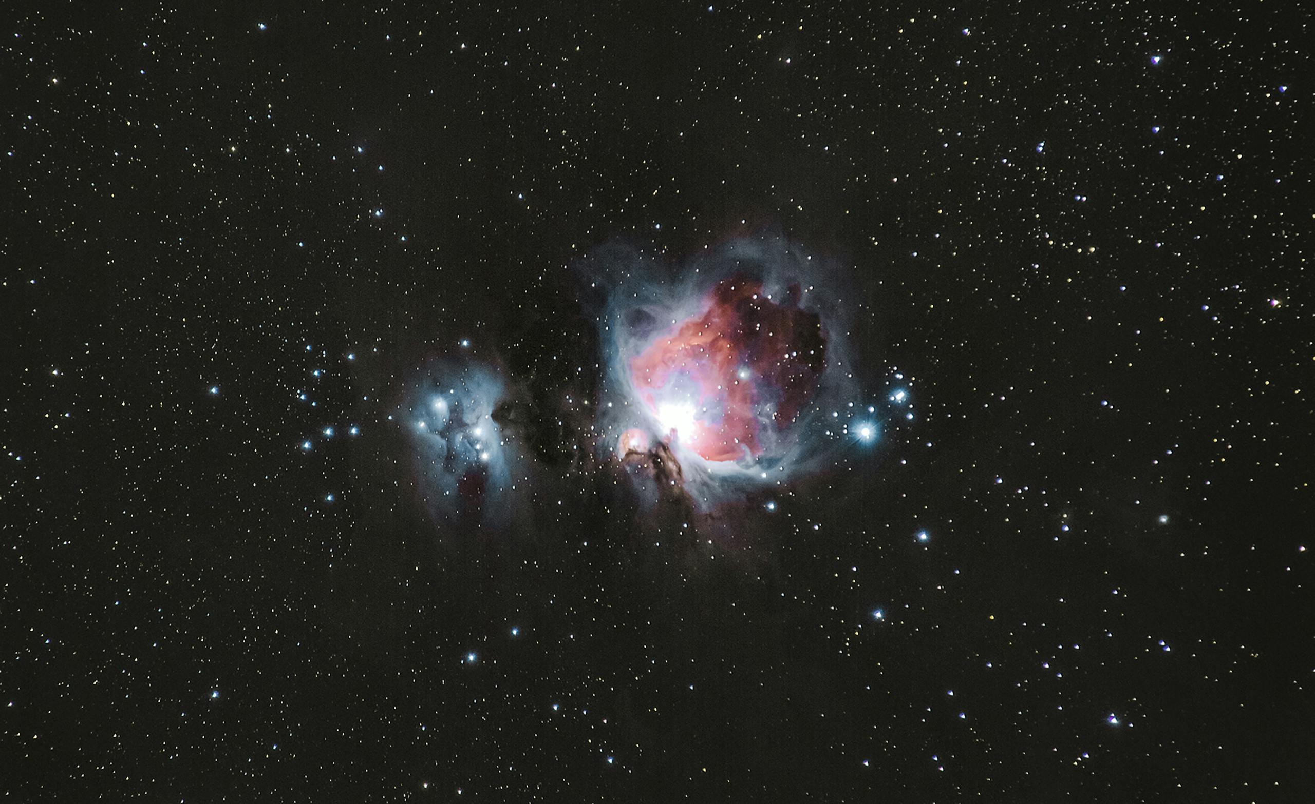 A breathtaking photograph of the Orion Nebula amidst a starry night sky, capturing celestial beauty.