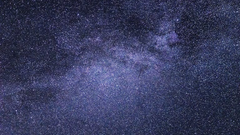 A breathtaking view of the starry night sky, showcasing a vibrant galaxy cluster.