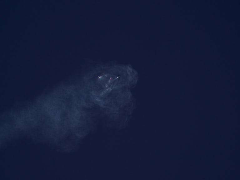 A mysterious smoke formation against a deep dark sky, creating an atmospheric and intriguing scene.
