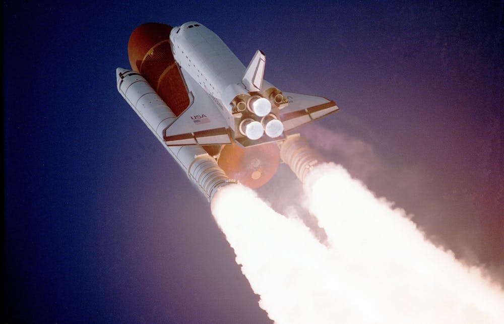 Rocket Launches Are Rising – But What Does That Mean for the Ozone Layer? A space shuttle launches into space, showcasing powerful rocket engines and USA branding.