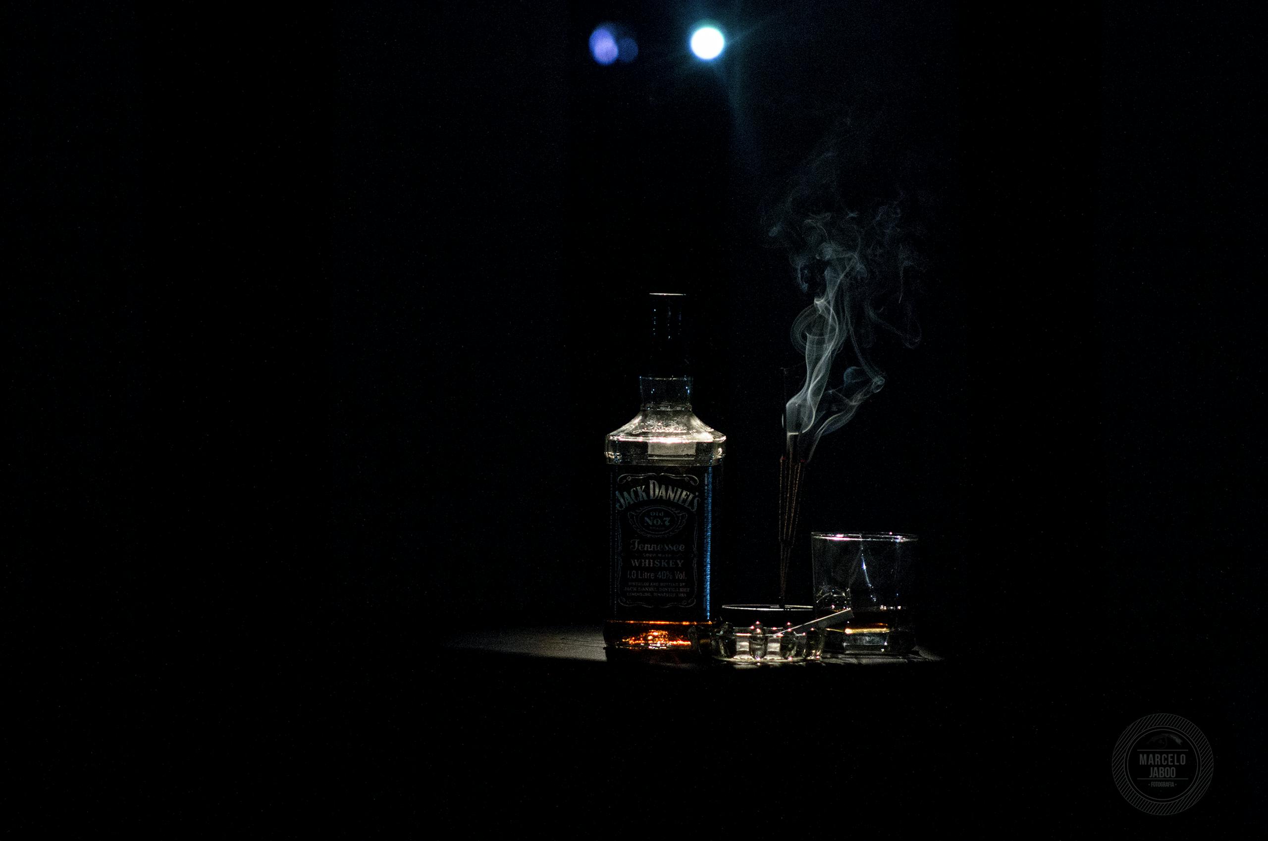 Four New Discoveries About Beer and Wine That Could Change the Way You Drink A dramatic whiskey bottle with smoke on a dark background, accented by soft lighting.