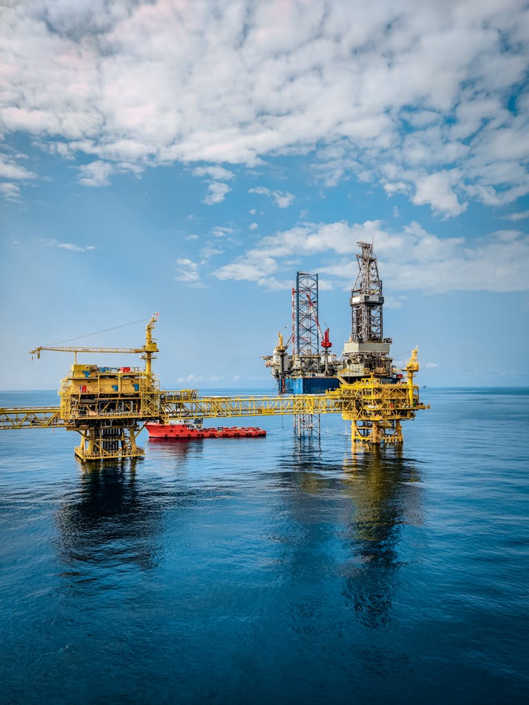 AI Breakthrough from James Cook University Fuses Satellite Data for Unprecedented Oil Spill Detection A vibrant offshore oil rig under a clear sky, reflecting in the calm blue sea.