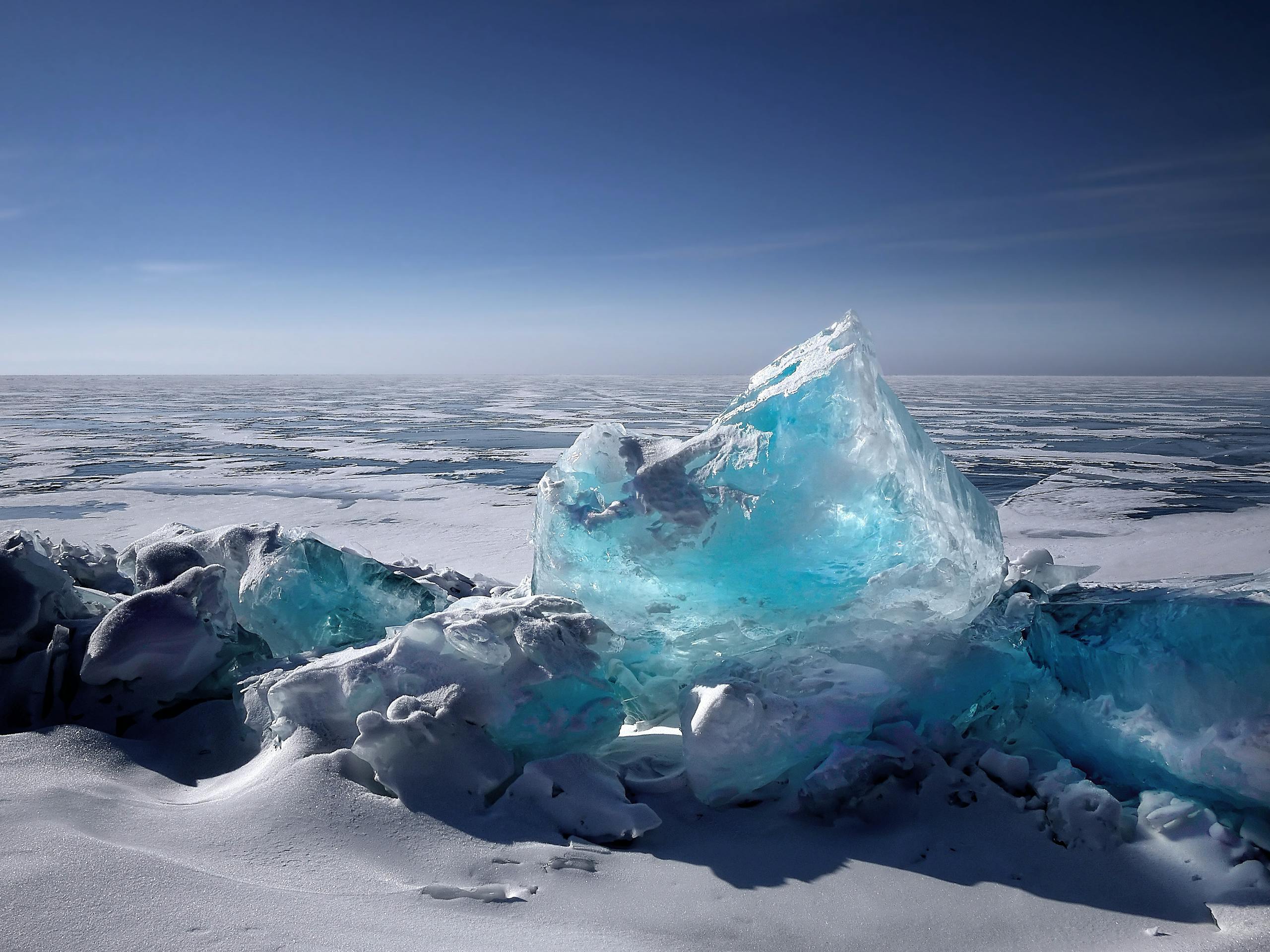 Retreating Glaciers Could Be Sending Fewer Nutrients to the Ocean, Scientists Warn Captivating ice formation on a frozen lake under a bright blue sky during winter.