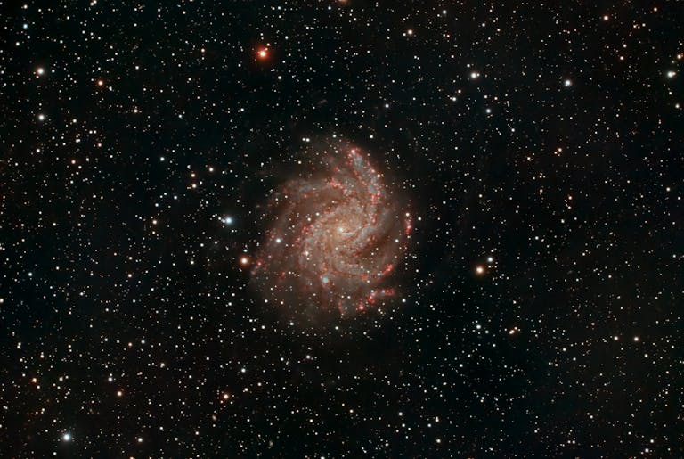 Capture of a spiral galaxy surrounded by stars, showcasing the vastness of space.
