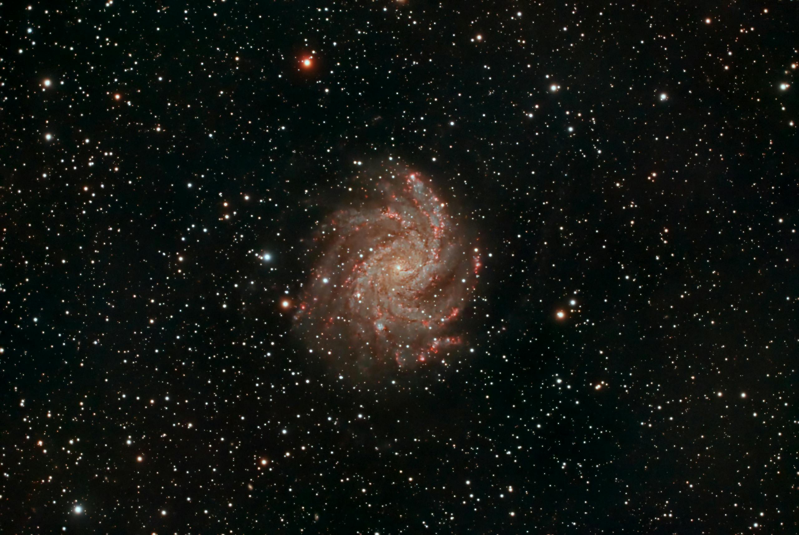 Capture of a spiral galaxy surrounded by stars, showcasing the vastness of space.