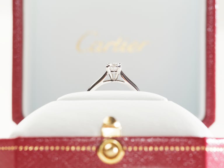 Elegant diamond engagement ring in a luxurious red box.