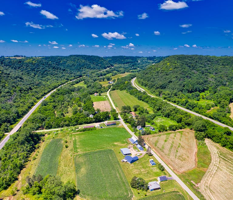 Retired Farmlands Could Store Carbon for Decades, Says 40-Year Study Stunning aerial view of lush farmland and rolling hills in Dakota, Minnesota during summer.