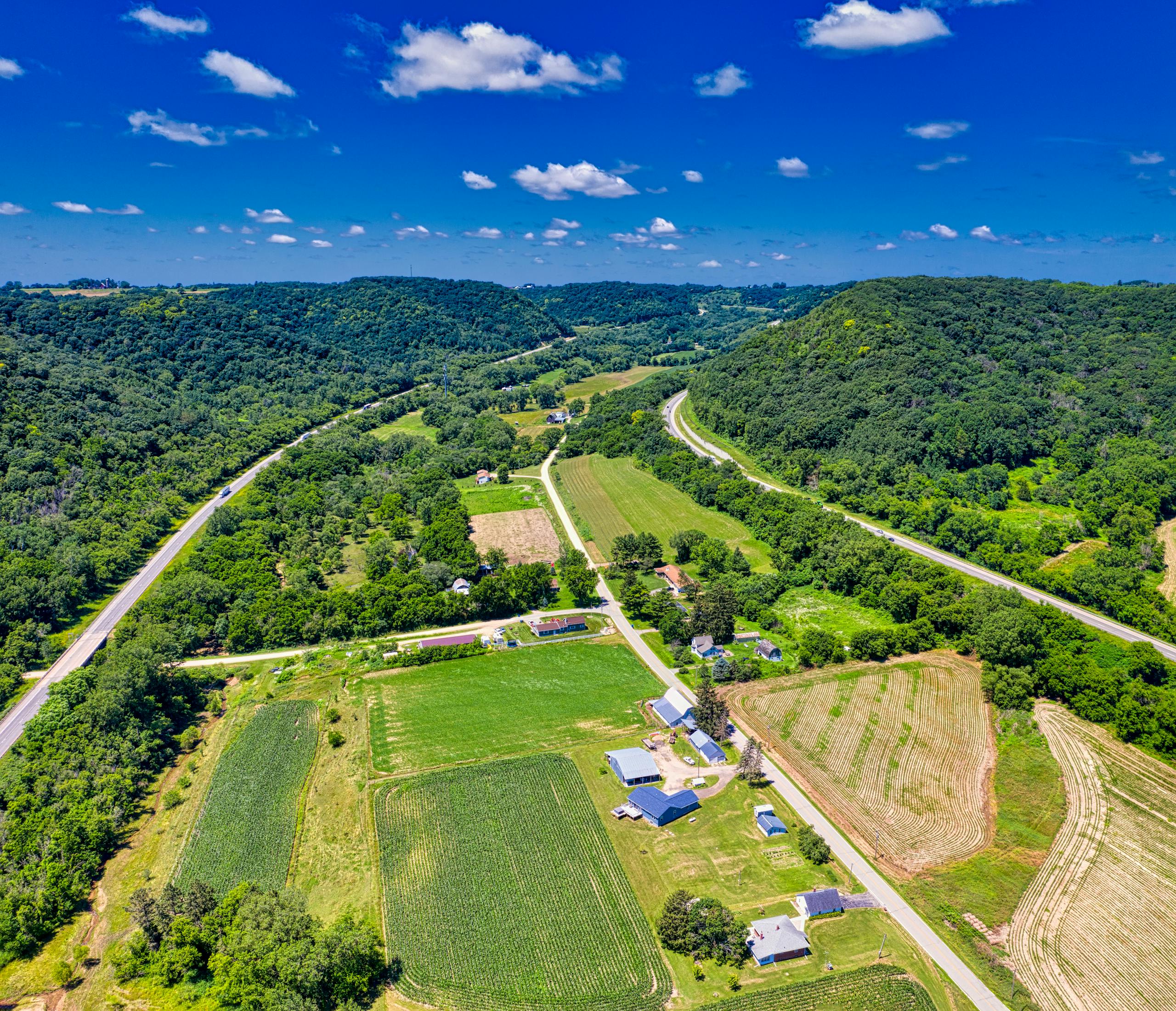 Retired Farmlands Could Store Carbon for Decades, Says 40-Year Study Stunning aerial view of lush farmland and rolling hills in Dakota, Minnesota during summer.