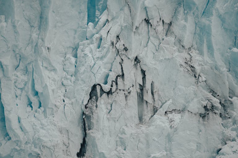 Close-up view of a rugged glacier ice cliff, showcasing nature's icy magnificence.
