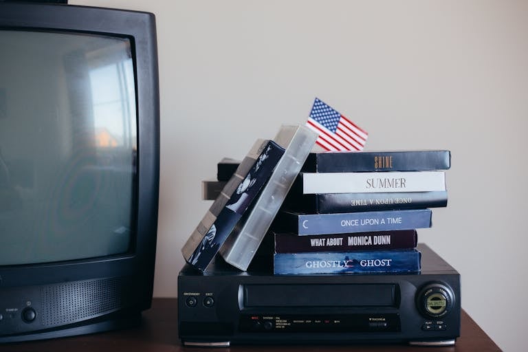 A nostalgic scene with VHS tapes, a vintage TV, and a small American flag.