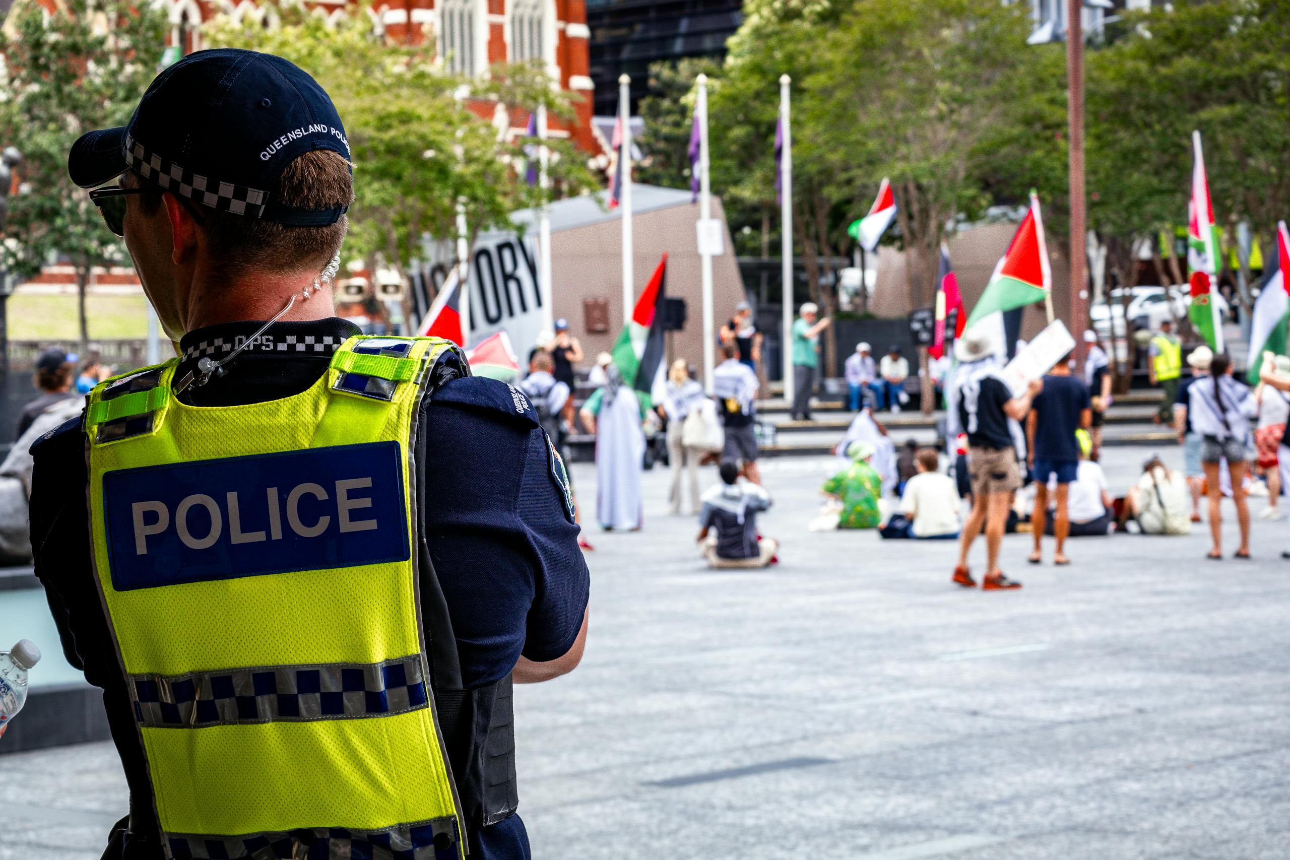 A police officer oversees a peaceful protest in Brisbane City, Australia.