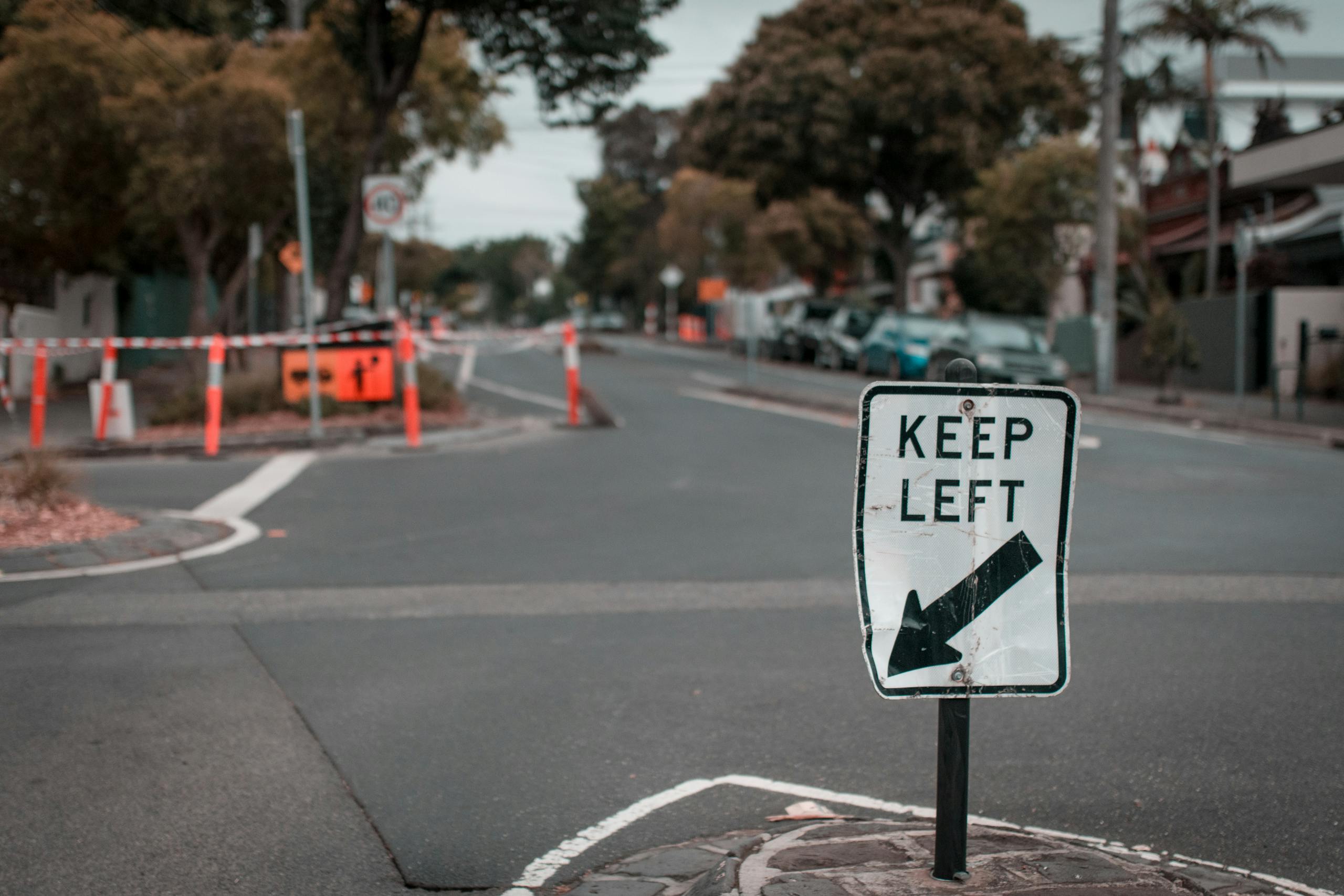 A suburban street view with a 'Keep Left' sign and road construction in Melbourne.