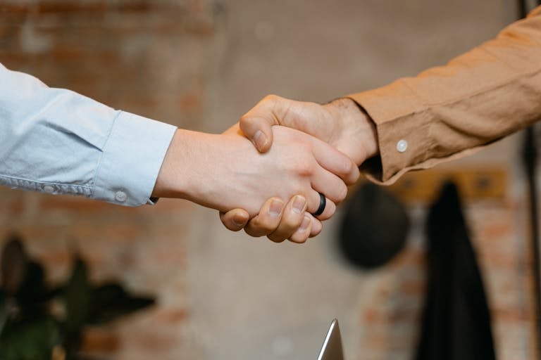 Close-up of a firm handshake symbolizing a business deal agreement.