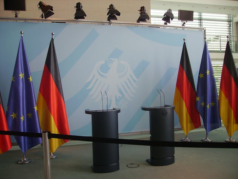 Empty podiums with German and EU flags in Federal Chancellery, Berlin.