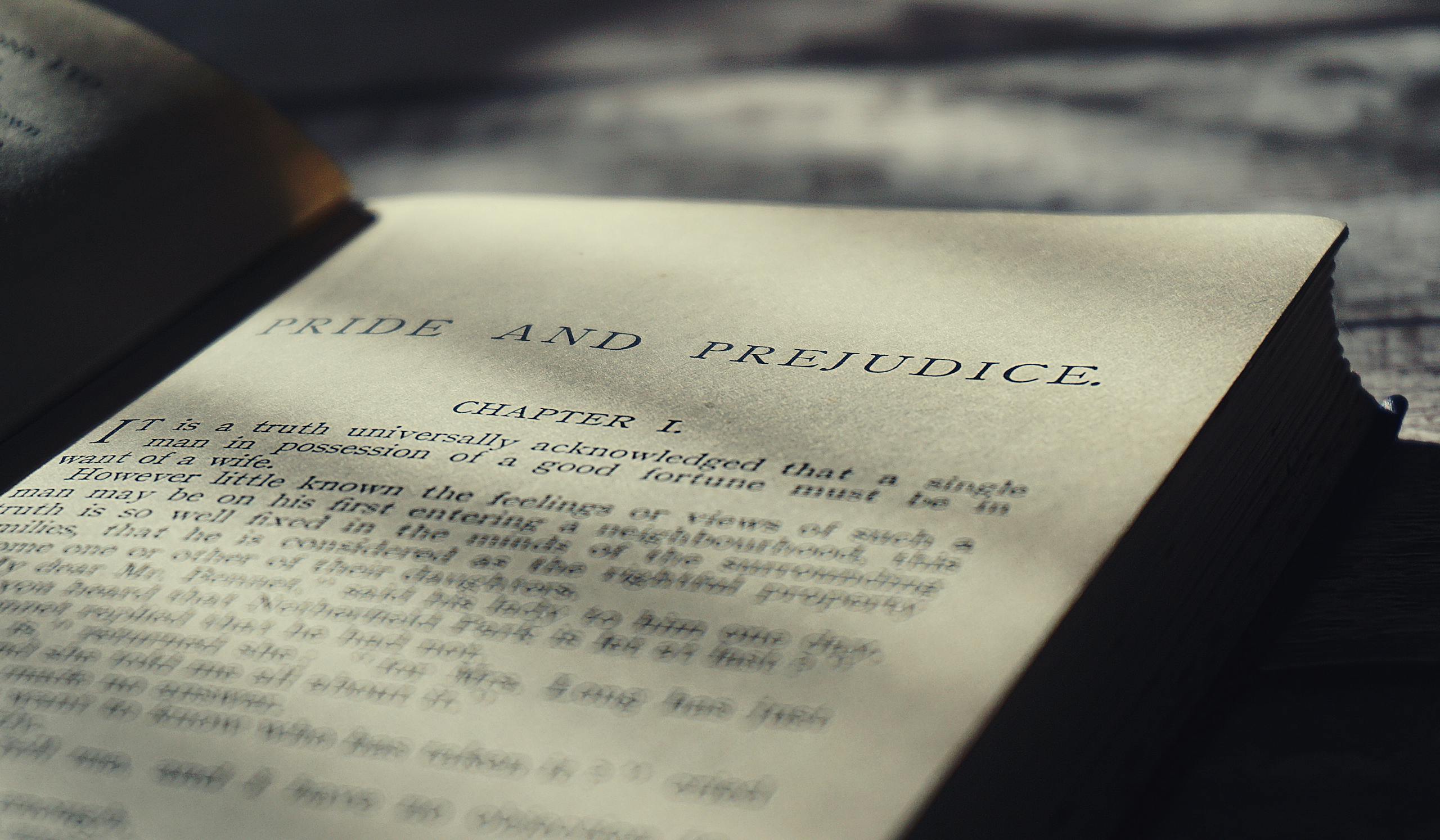 Close-up view of an open vintage page from Pride and Prejudice in warm sunlight.