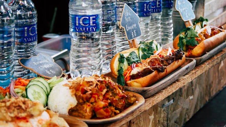 Explore tasty street food and beverages at Greenwich Market in London.