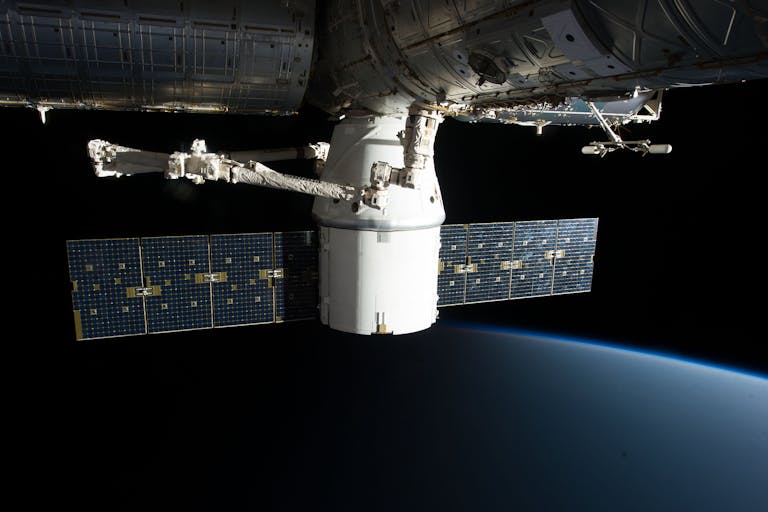 Image of the International Space Station floating above Earth with visible solar panels.
