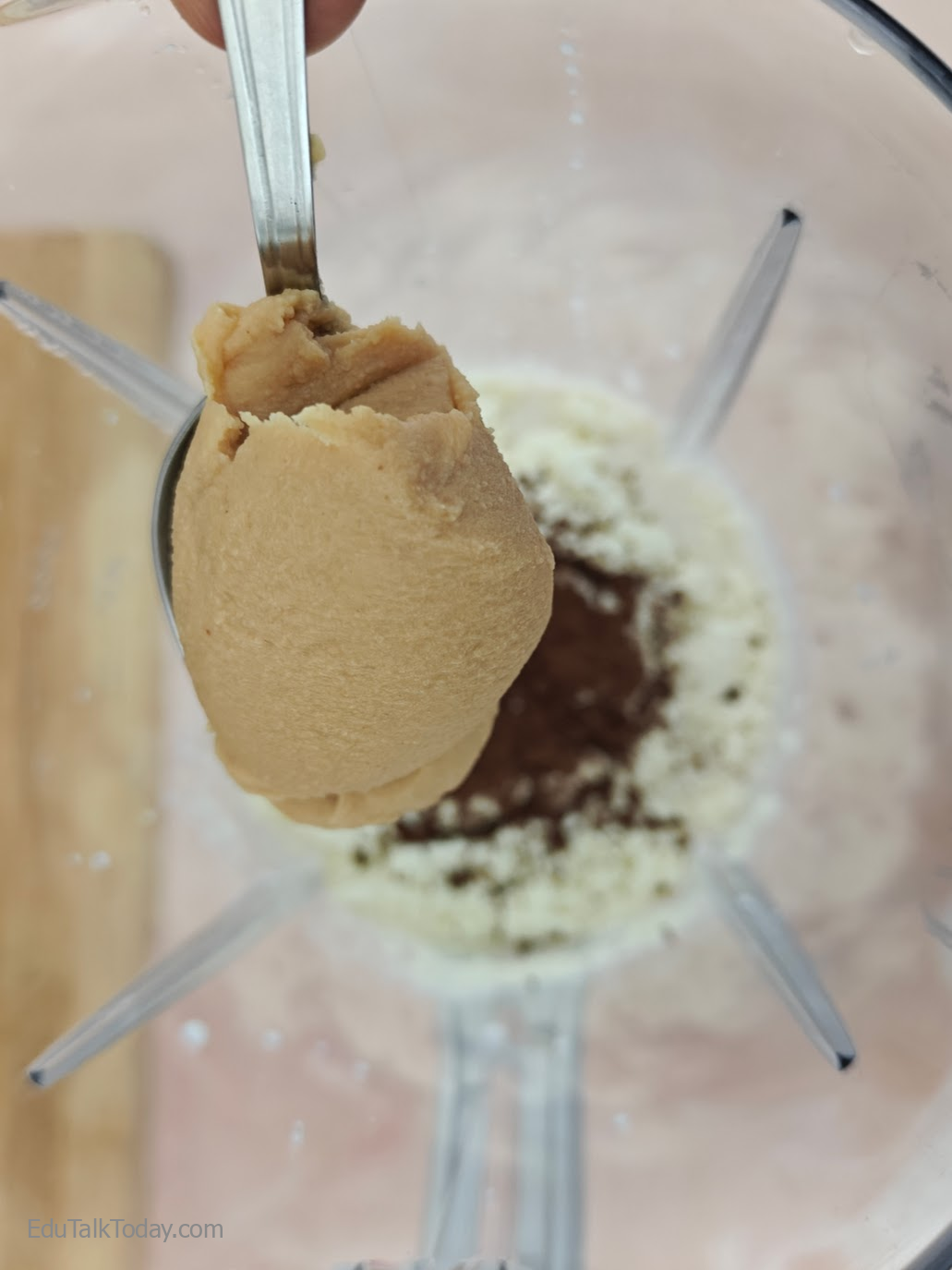 Peanut Butter Oats Smoothie Peanut butter being added to blender ingredients for peanut butter oats smoothie