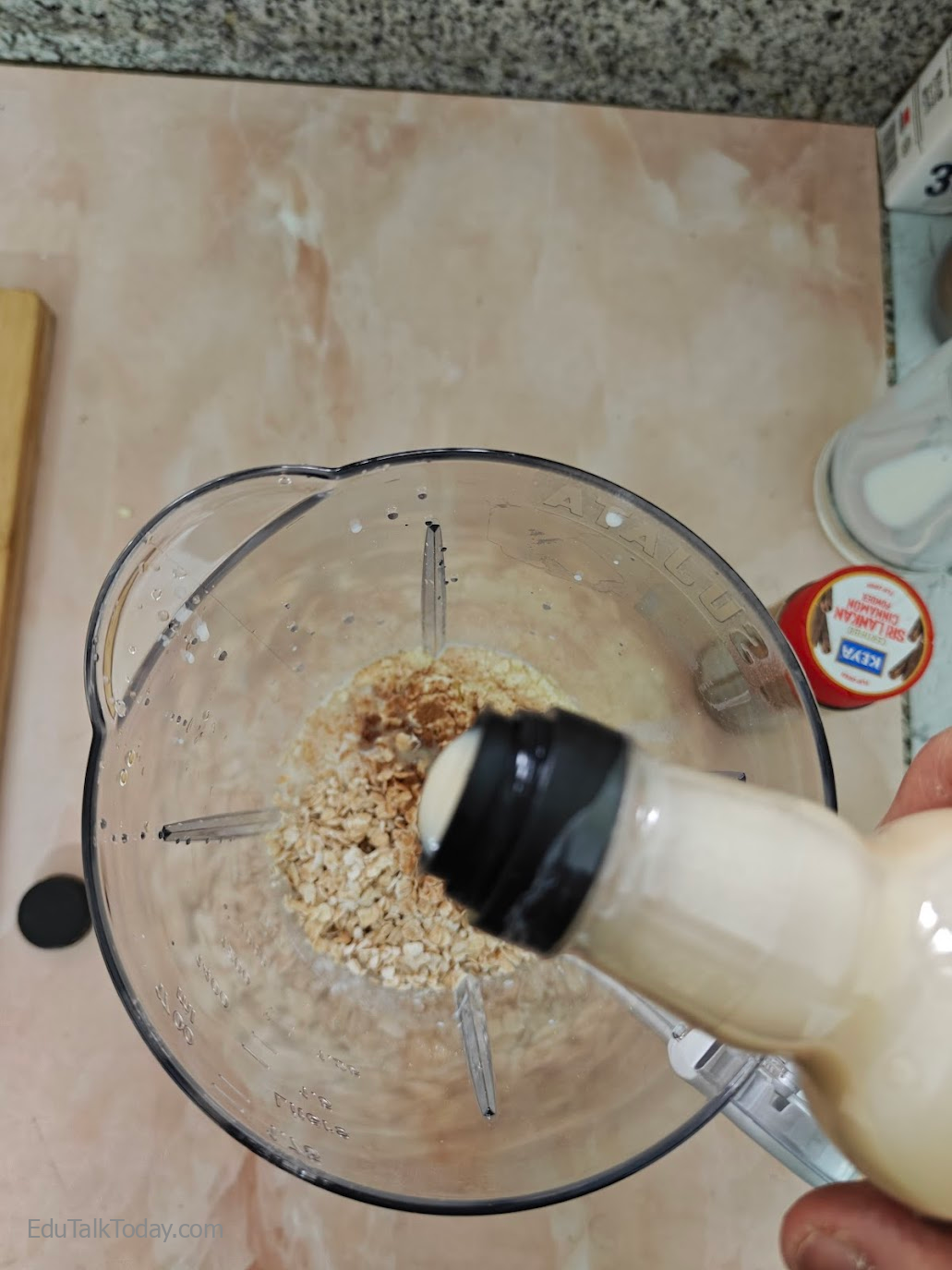 Oats Tahini Protein Smoothie White tahini paste being added to the blender jar